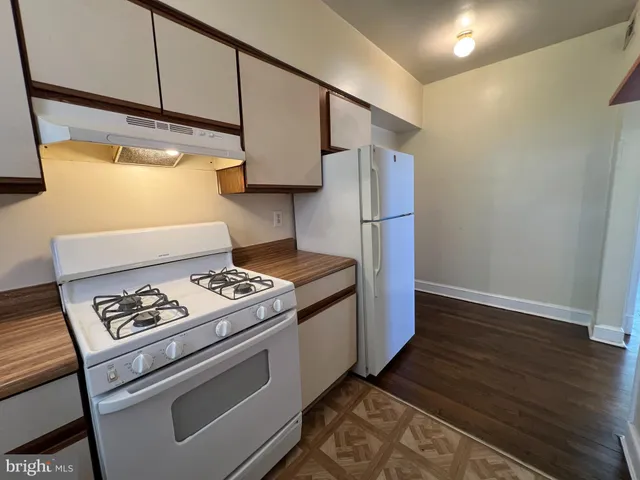 a kitchen with a stove and a refrigerator