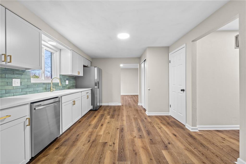 10 Rushmore Drive Pittsburgh, PA 15235 - Photo 6 of 37 a large kitchen with wooden floor and stainless steel appliances