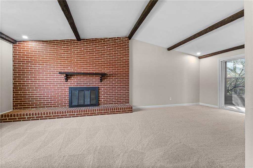 10 Rushmore Drive Pittsburgh, PA 15235 - Photo 9 of 37 a view of an empty room with wooden floor and a fireplace