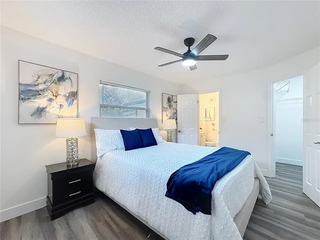 a bedroom with a large bed and a chandelier
