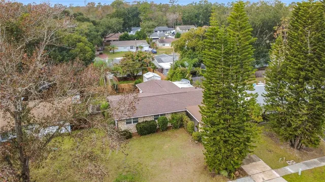 an aerial view of a house with a yard