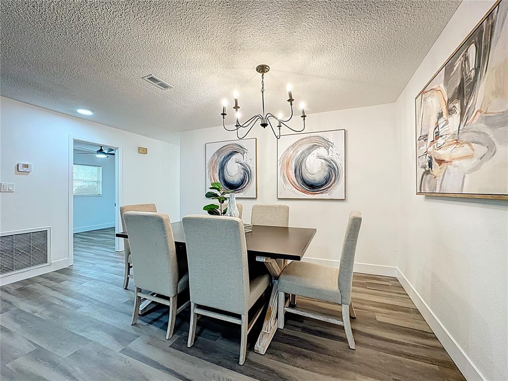 116 Exeter Avenue Longwood, FL 32750 - Photo 4 of 21 a view of a dining room with furniture and wooden floor