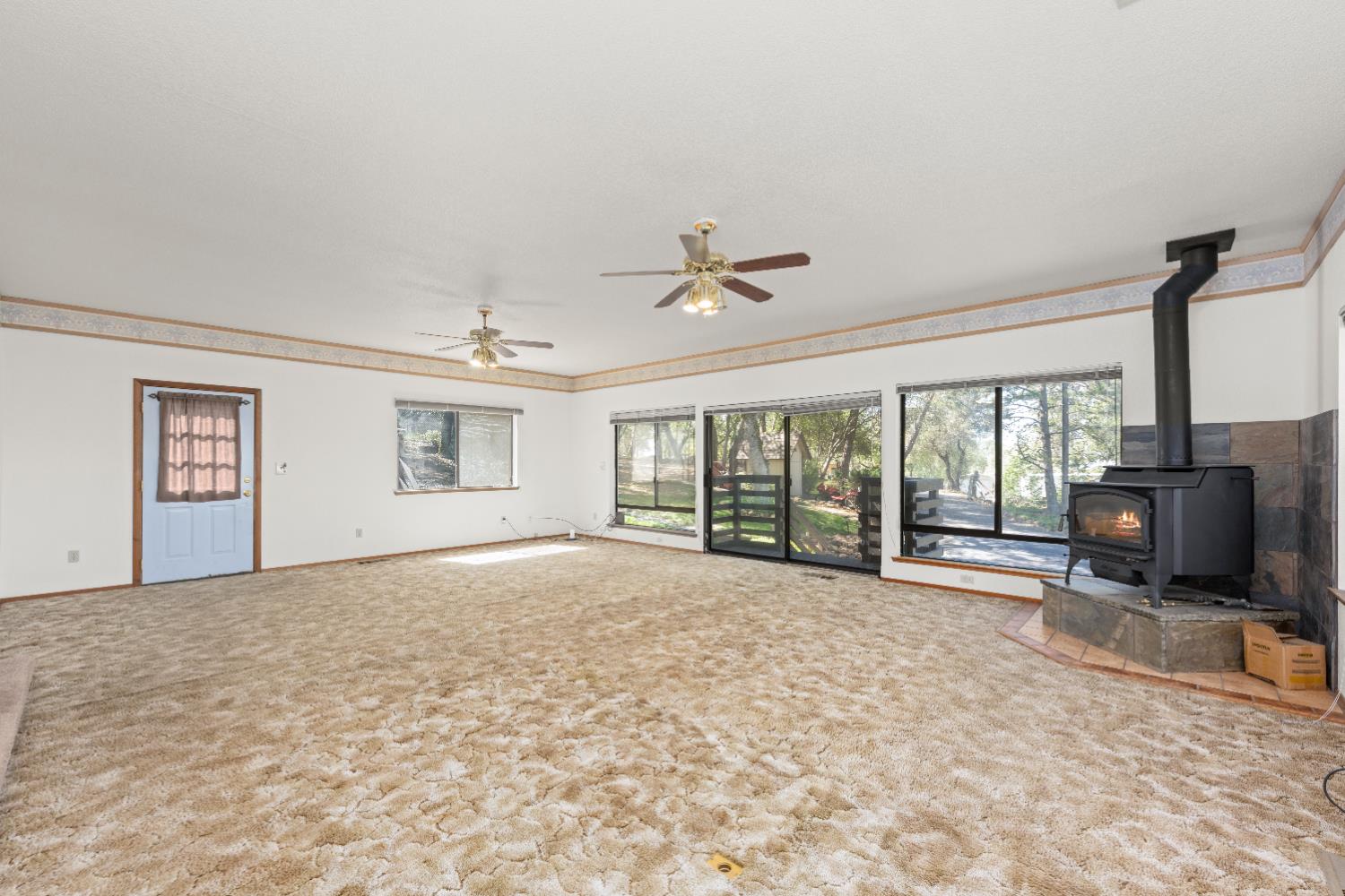 14800 McElroy Road Auburn, CA 95602 - Photo 13 of 39 a view of an empty room with a fireplace and a flat screen tv