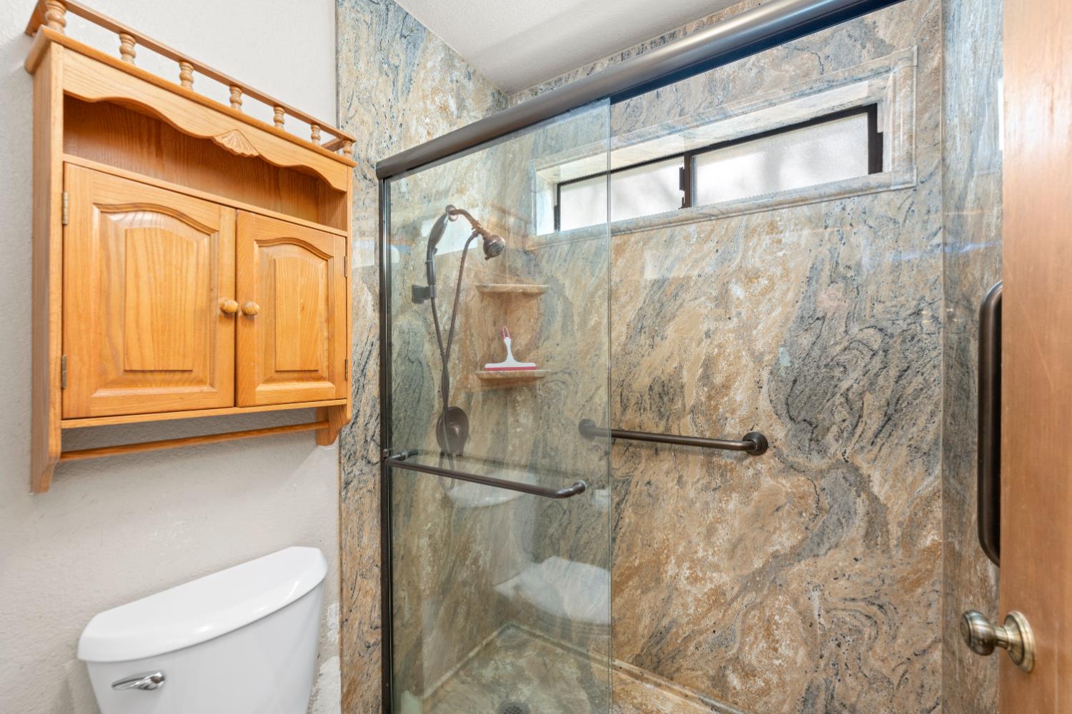 14800 McElroy Road Auburn, CA 95602 - Photo 18 of 39 a bathroom with a toilet and a shower