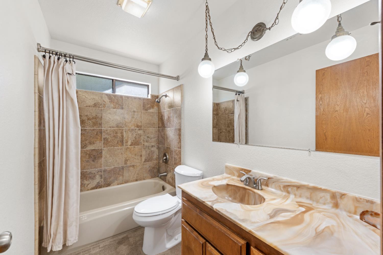14800 McElroy Road Auburn, CA 95602 - Photo 22 of 39 a bathroom with a sink a toilet and shower