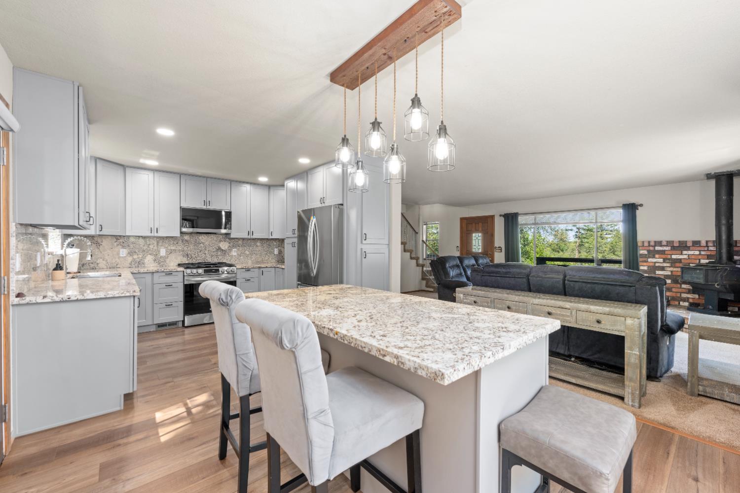 14800 McElroy Road Auburn, CA 95602 - Photo 6 of 39 a open kitchen with granite countertop and chairs