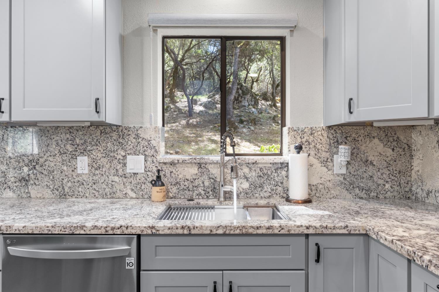 14800 McElroy Road Auburn, CA 95602 - Photo 8 of 39 a kitchen with granite countertop a sink and a window