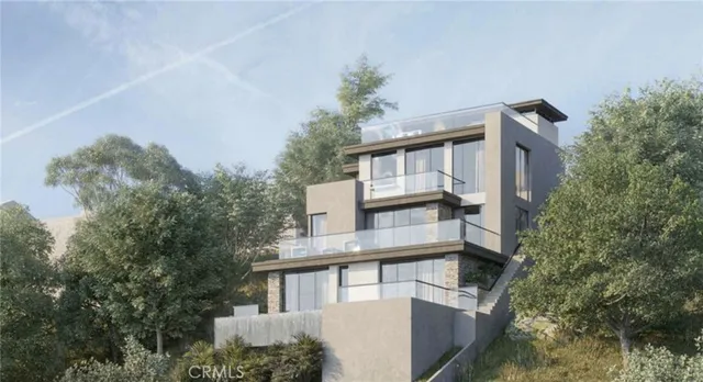 a front view of a house with a tree