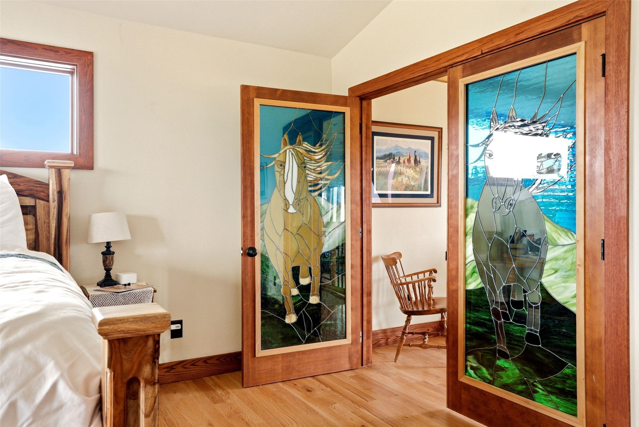 679 Hidden Valley Road North Florence, MT 59833 - Photo 44 of 85 Custom stained-glass doors with wood frames, complemented by wood-finish flooring and solid wood trim