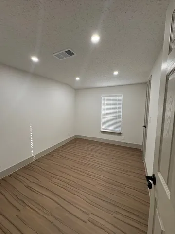 a view of a room with wooden floor