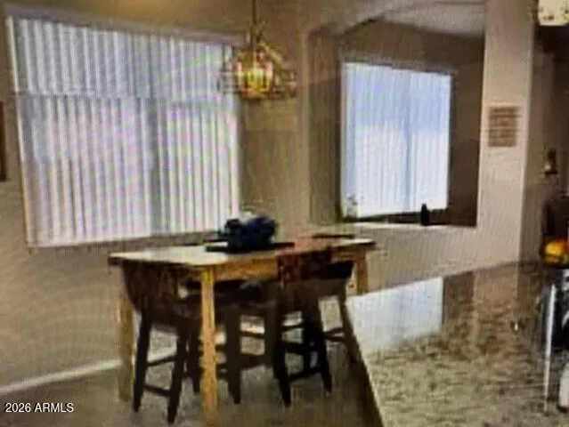a view of a dining room with furniture and window