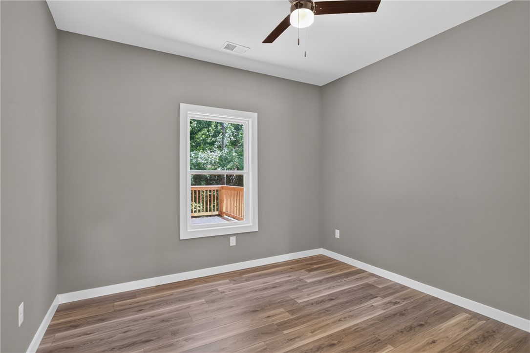 223 Maple Drive Anderson, SC 29621 - Photo 28 of 45 A well-lit room featuring durable wood flooring and a view of surrounding nature.