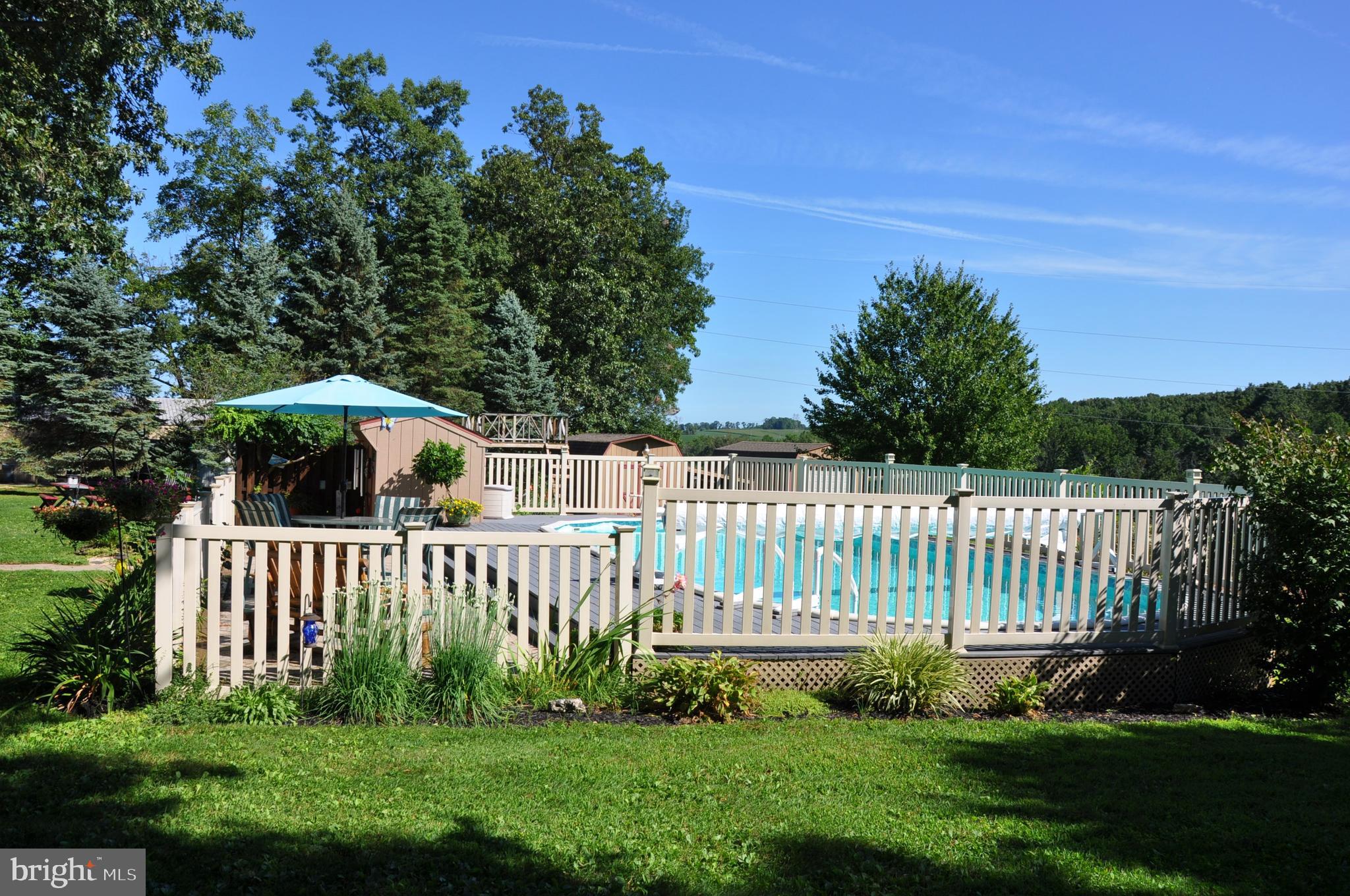 12473 Canning House Road Felton, PA 17322 - Photo 4 of 72 Summer view of the fenced pool area.
