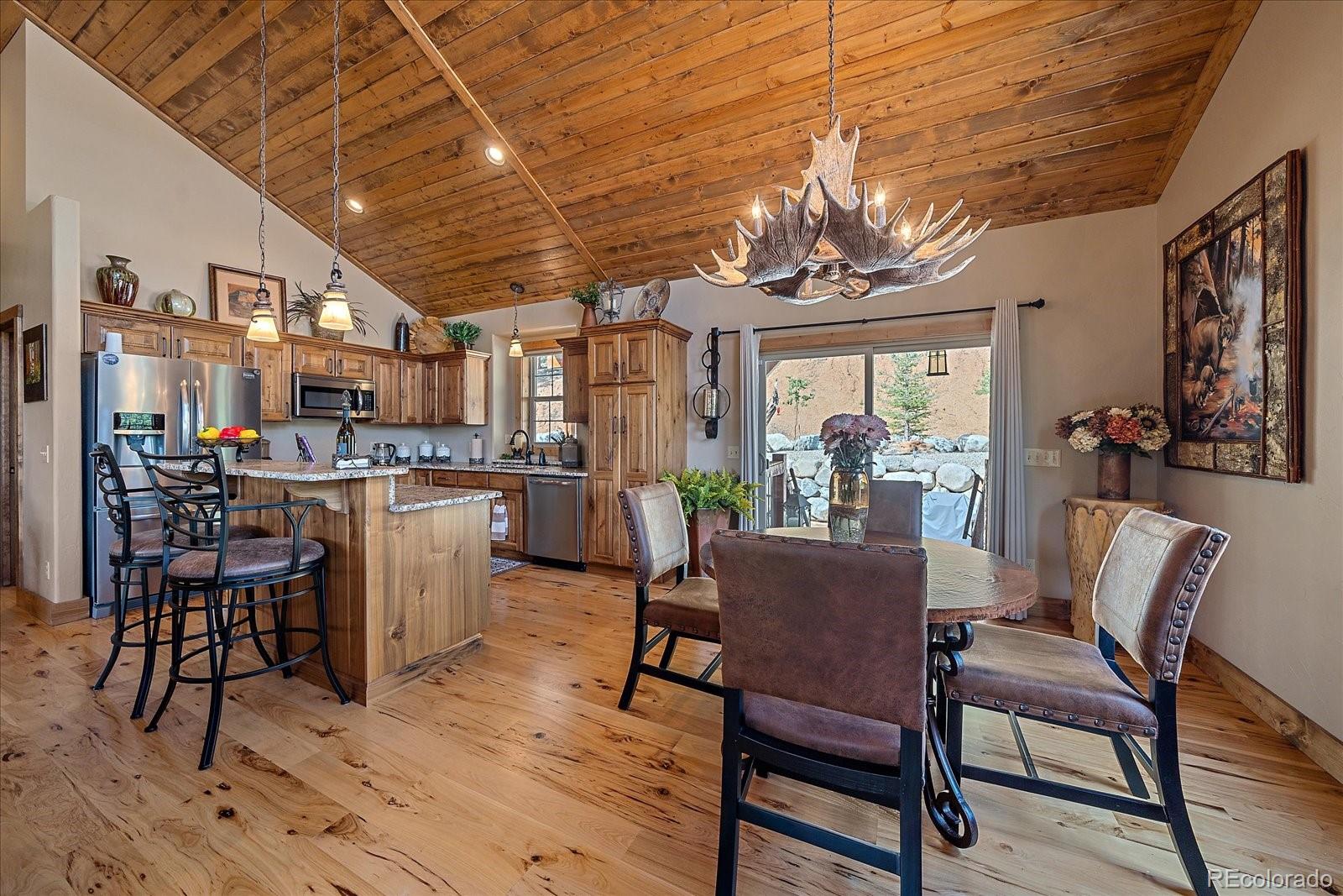 2894 County Road 43 Bailey, CO 80421 - Photo 12 of 48 a dining room with furniture a chandelier and wooden floor