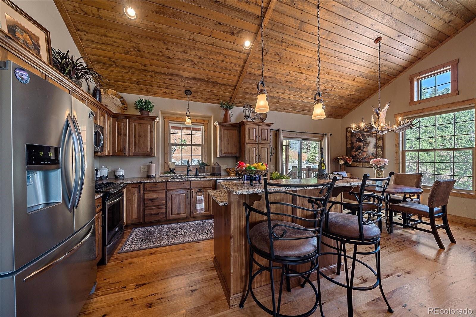 2894 County Road 43 Bailey, CO 80421 - Photo 13 of 48 a view of a dining room with furniture window and wooden floor