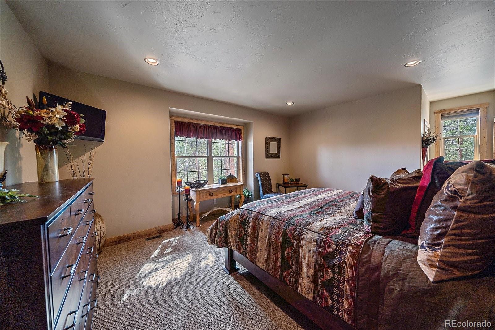 2894 County Road 43 Bailey, CO 80421 - Photo 17 of 48 a bedroom with a bed and a window