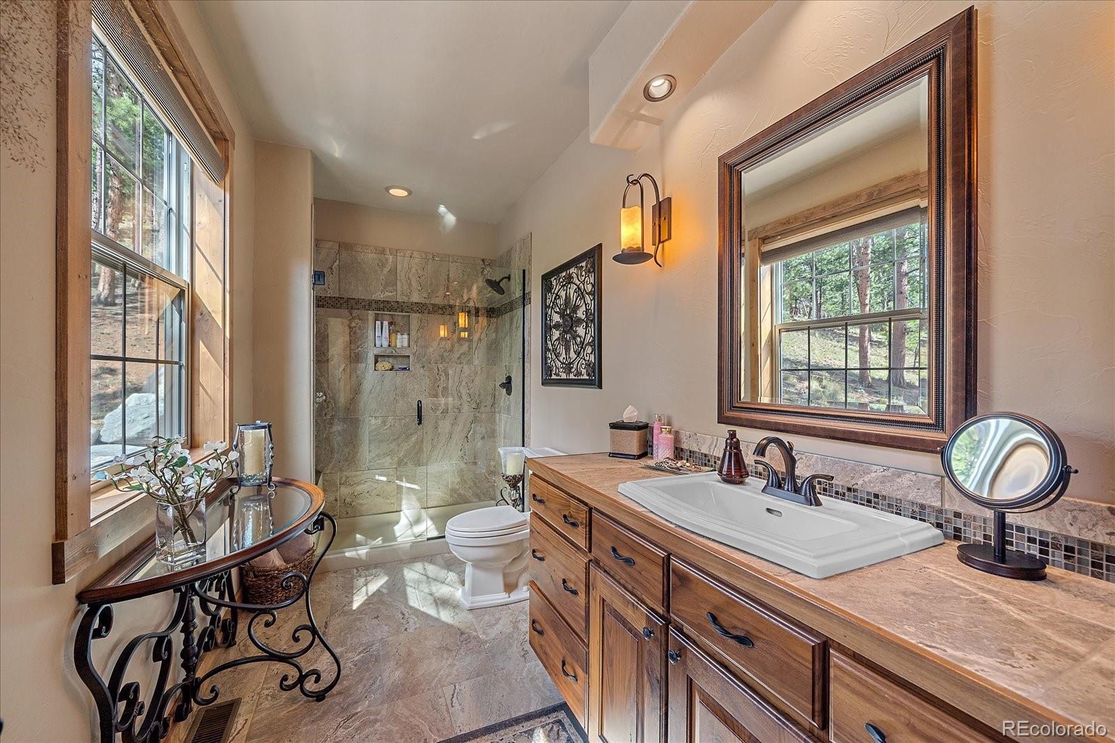 2894 County Road 43 Bailey, CO 80421 - Photo 19 of 48 a bathroom with double vanity and a window