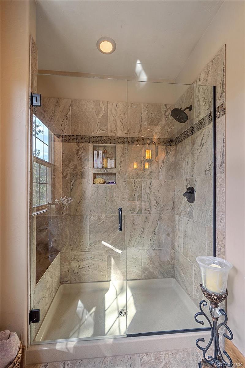 2894 County Road 43 Bailey, CO 80421 - Photo 20 of 48 a bathroom with a bathtub and a shower