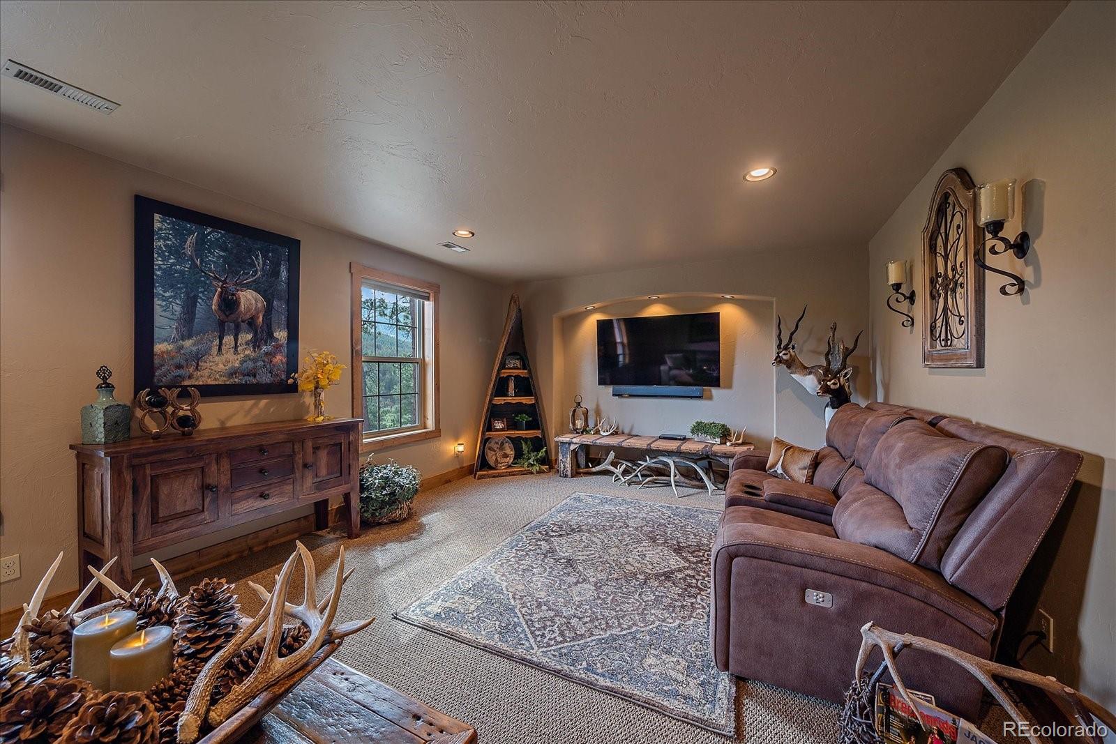 2894 County Road 43 Bailey, CO 80421 - Photo 24 of 48 a living room with furniture and a flat screen tv