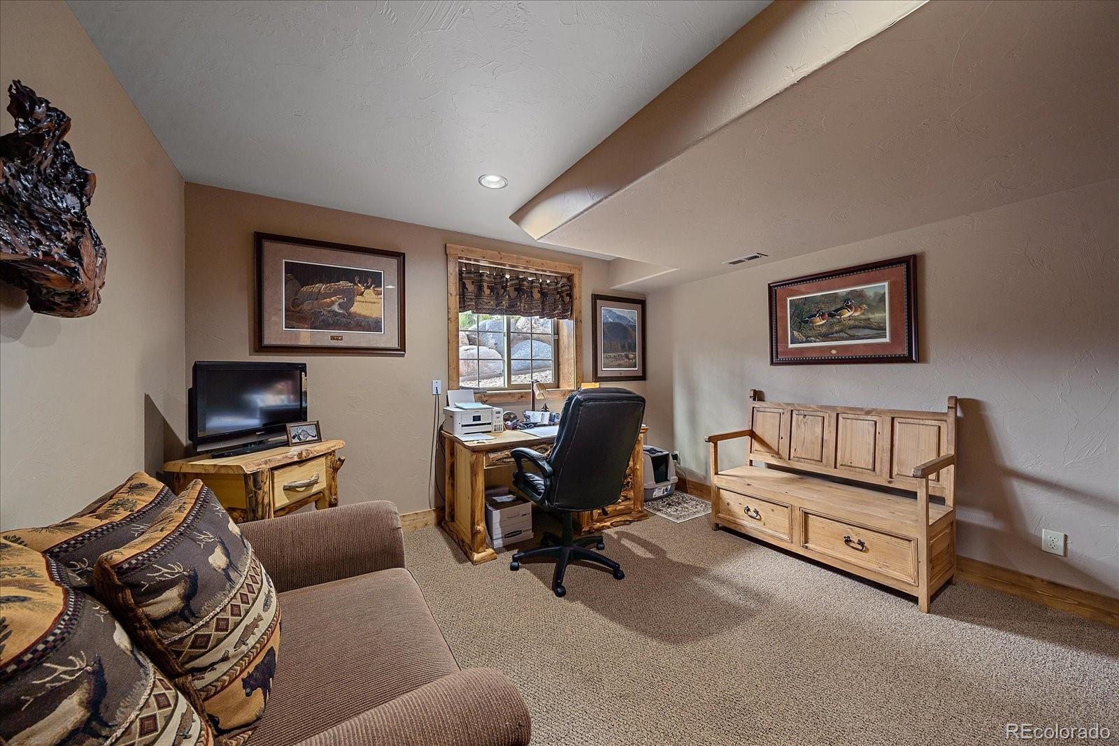 2894 County Road 43 Bailey, CO 80421 - Photo 25 of 48 a view of a livingroom with workspace and a couch