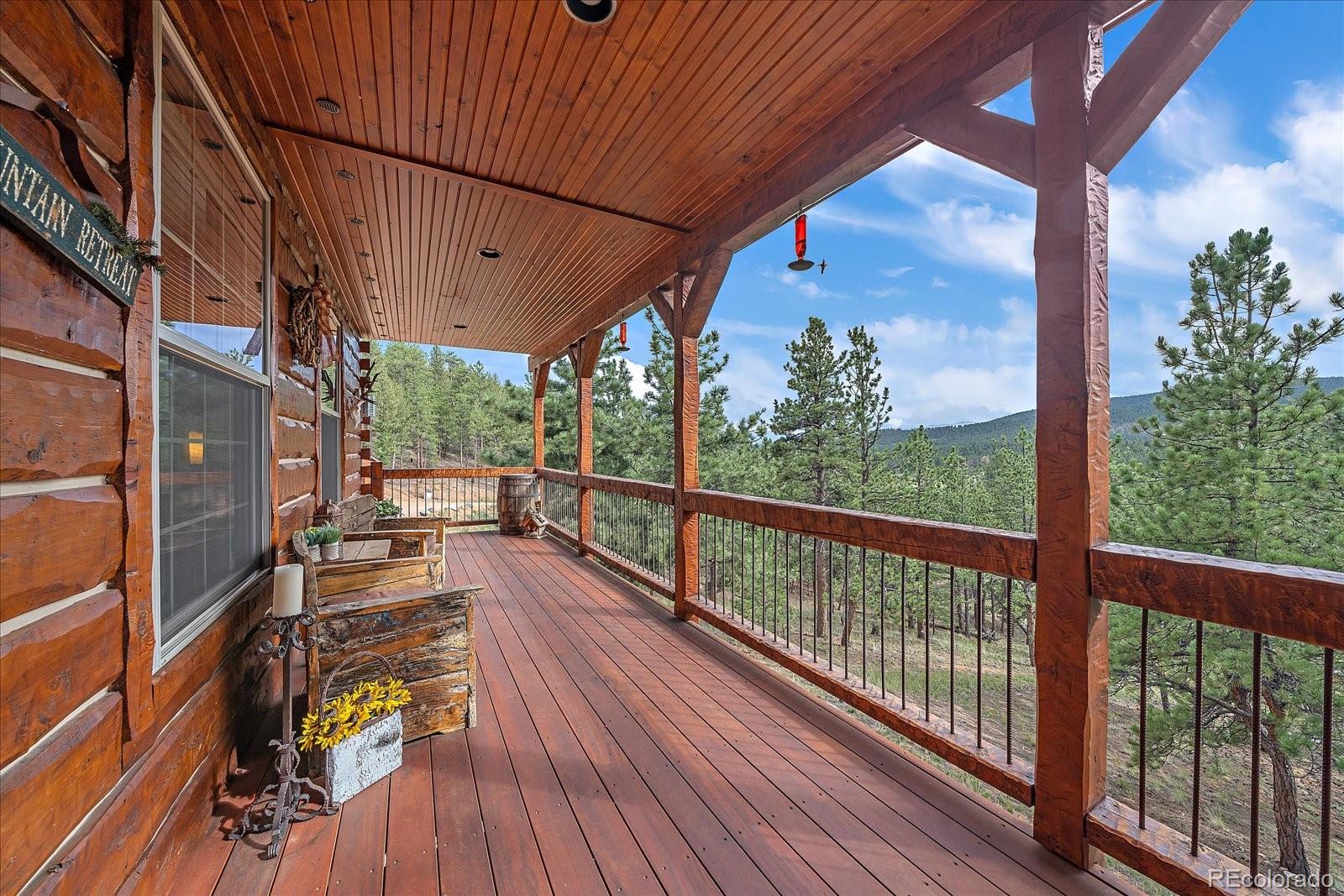 2894 County Road 43 Bailey, CO 80421 - Photo 28 of 48 a view of a balcony with chairs and wooden floor