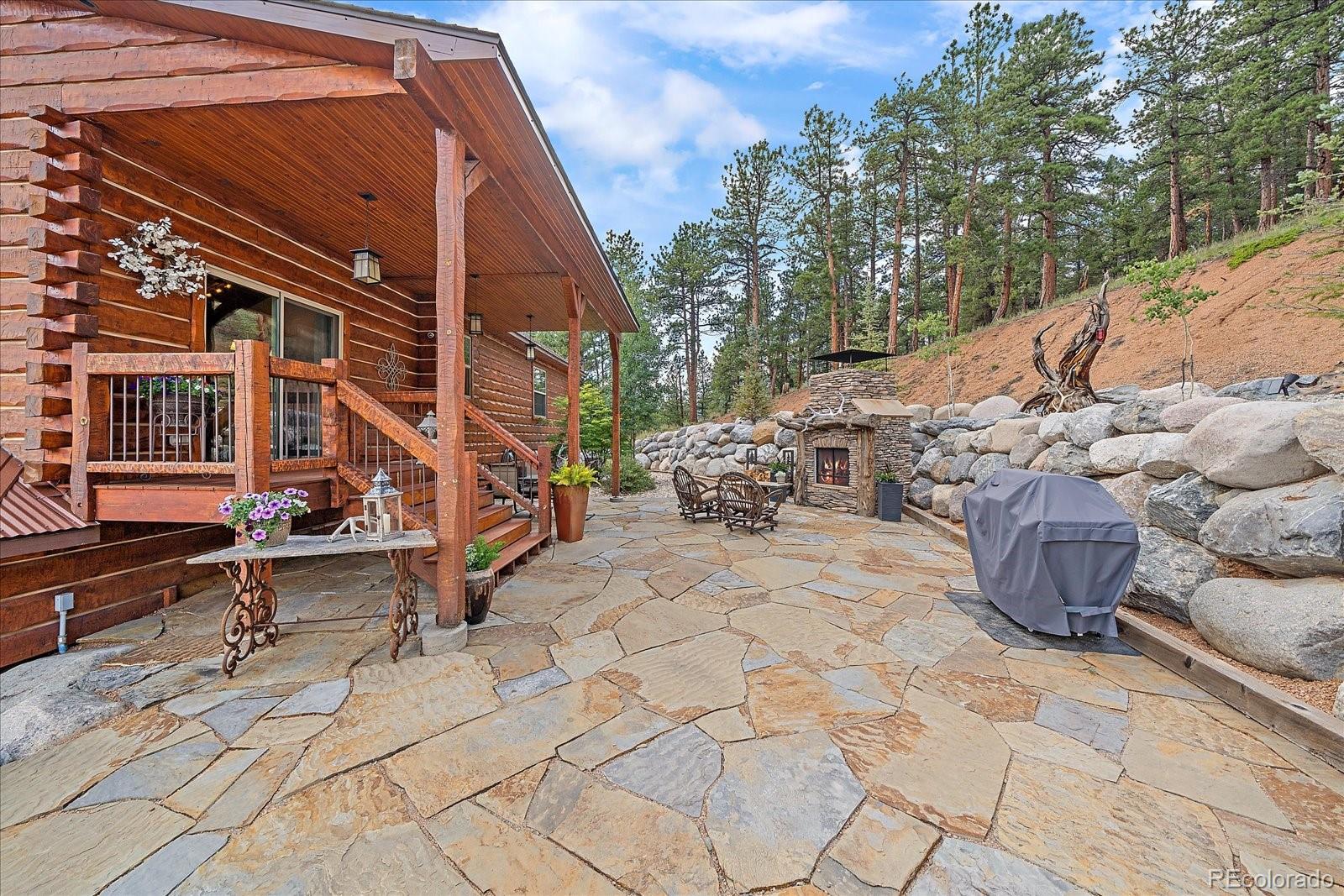 2894 County Road 43 Bailey, CO 80421 - Photo 31 of 48 a backyard of a house with barbeque oven
