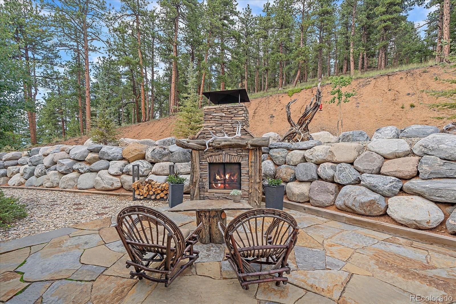 2894 County Road 43 Bailey, CO 80421 - Photo 32 of 48 a view of a chairs and bench with fire pit