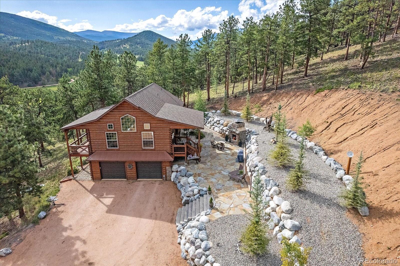 2894 County Road 43 Bailey, CO 80421 - Photo 33 of 48 a front view of a house with a yard and large tree