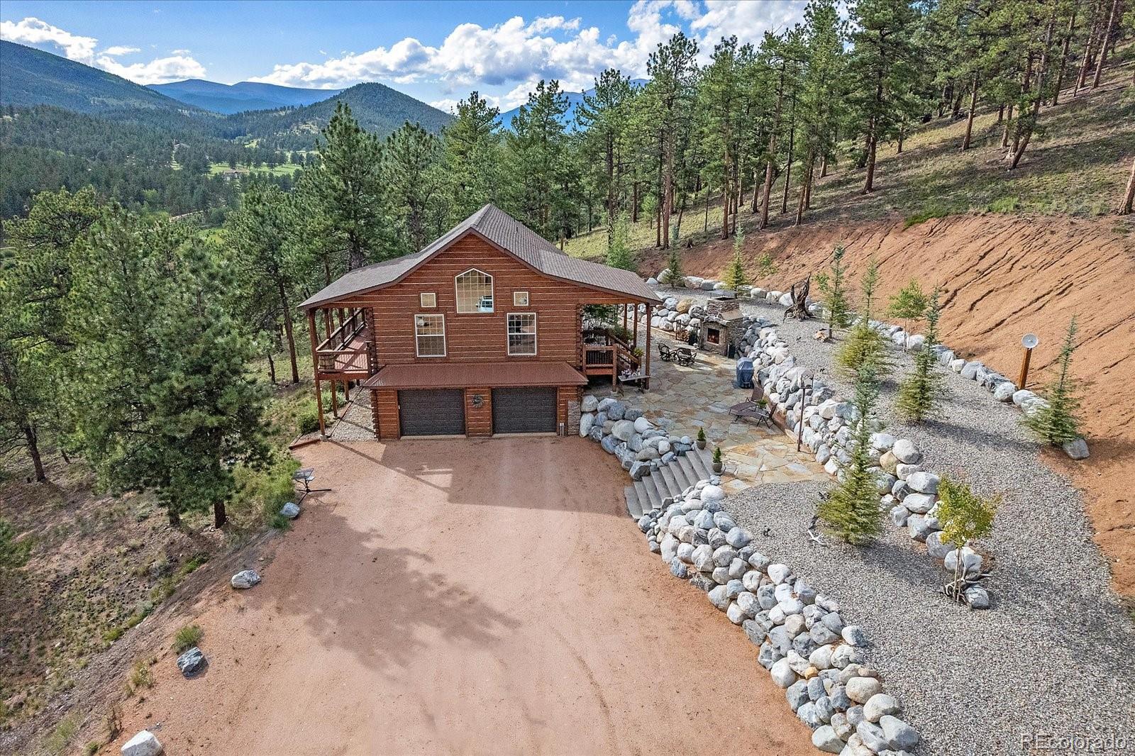 2894 County Road 43 Bailey, CO 80421 - Photo 34 of 48 a front view of a house with a yard