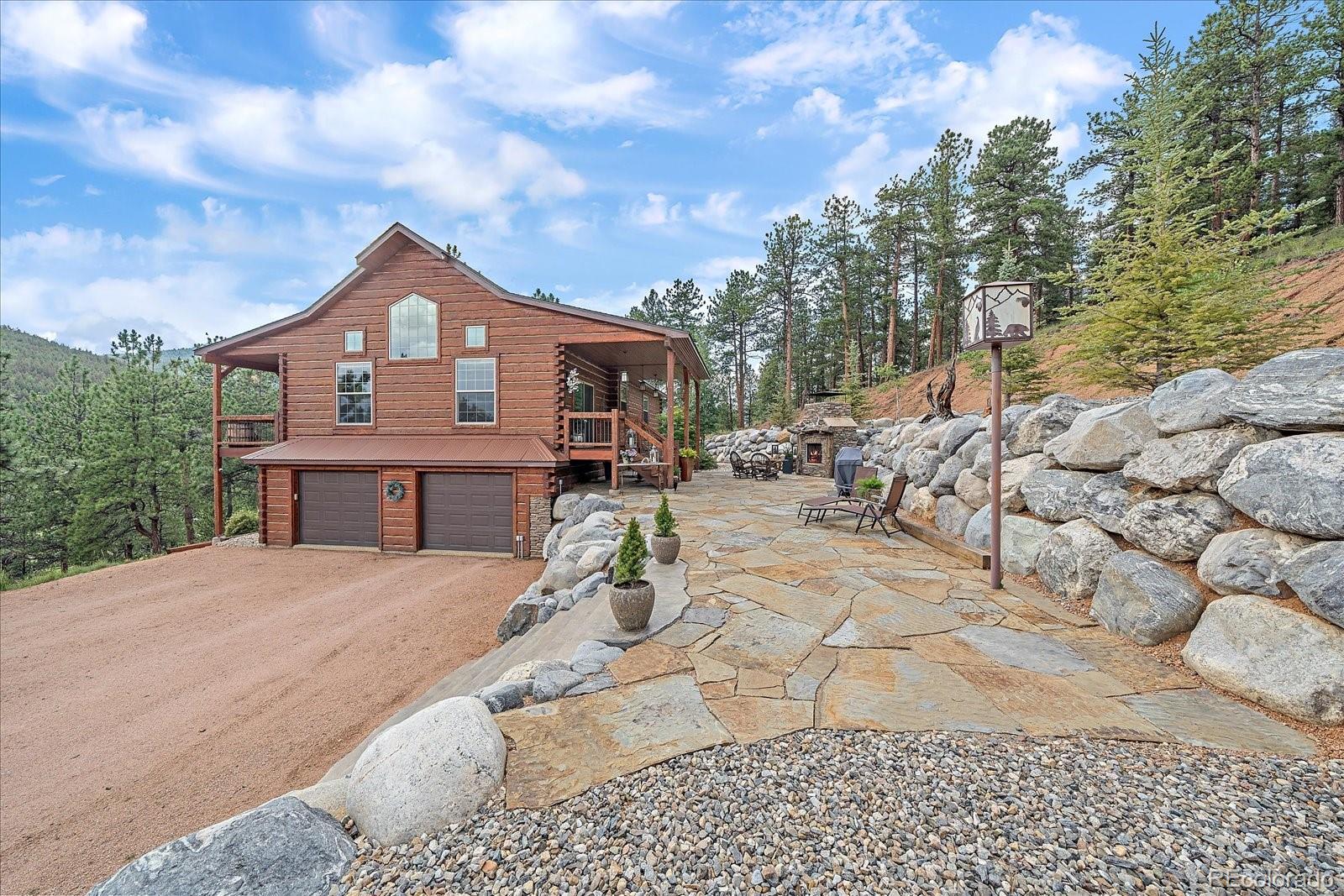 2894 County Road 43 Bailey, CO 80421 - Photo 4 of 48 a front view of a house with a yard