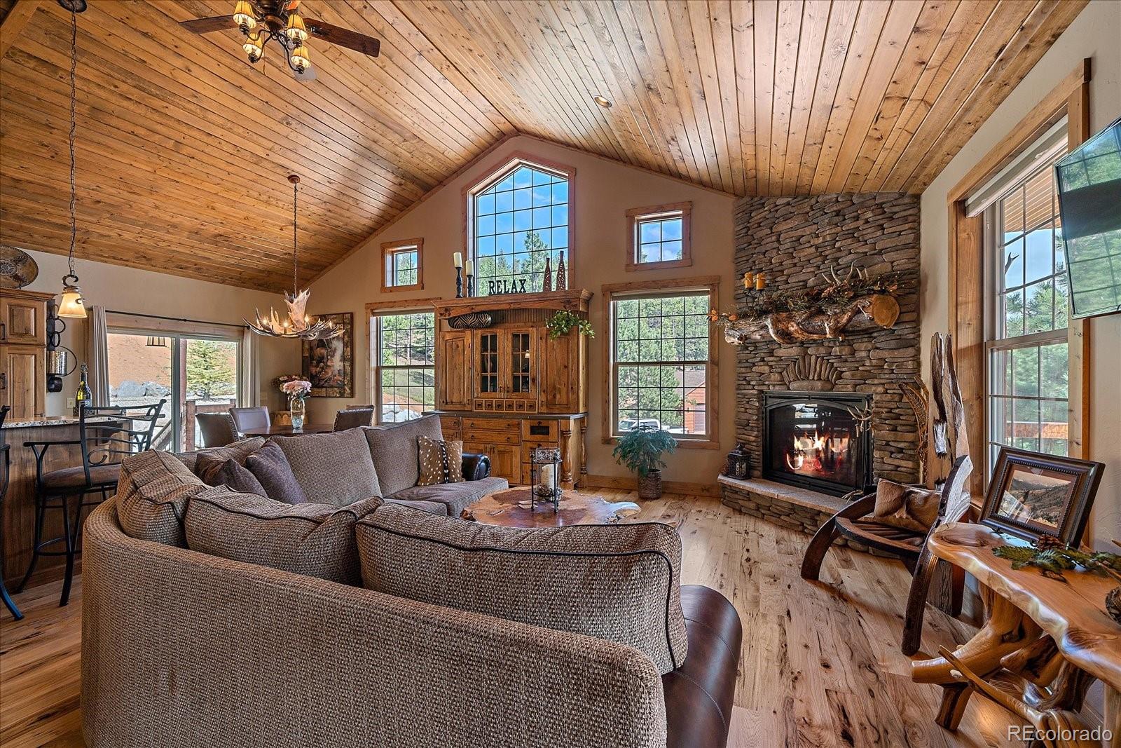 2894 County Road 43 Bailey, CO 80421 - Photo 8 of 48 a living room with furniture and a fireplace