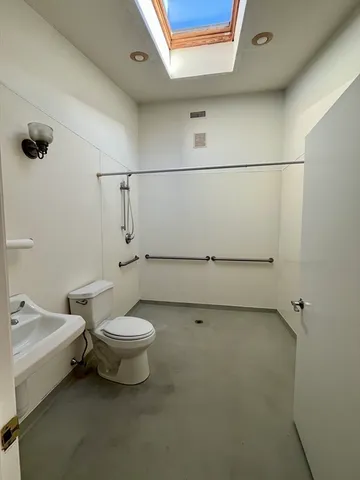 a bathroom with a toilet a sink and shower
