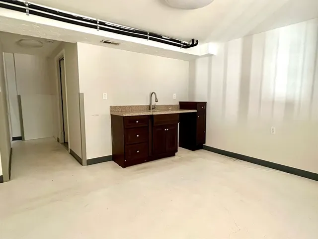 a room with a dresser and a window