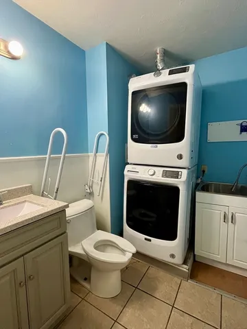 a living room with a sink and a fireplace