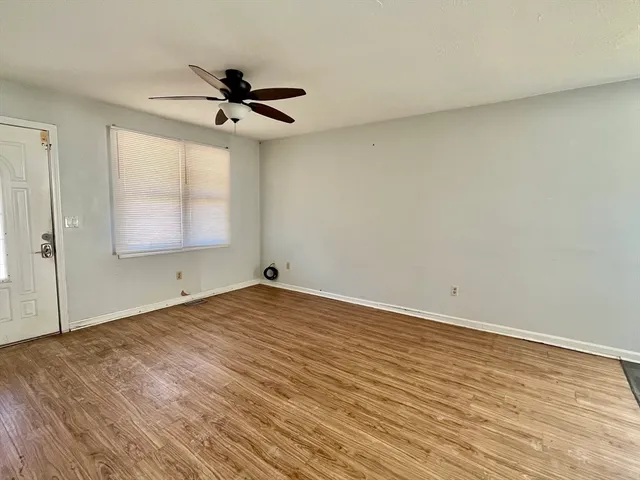 wooden floor in an empty room with a window