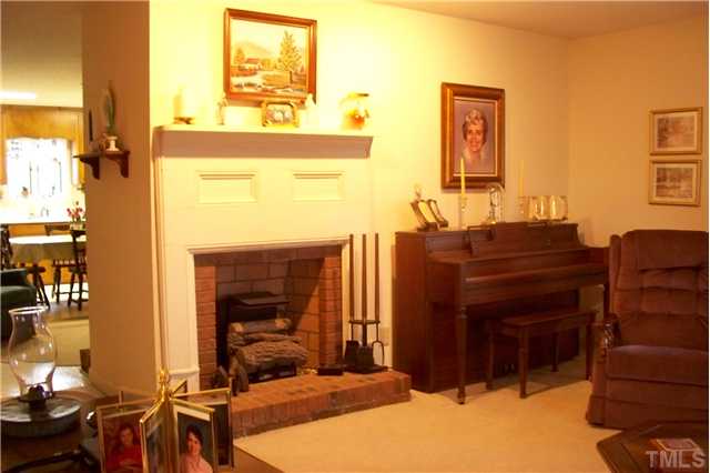 Foyer to left of living, then into sitting area with gas log fplace