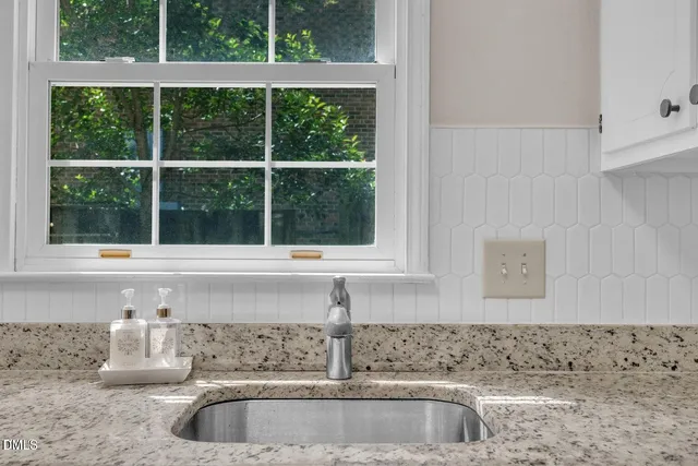 a kitchen with a sink and a window