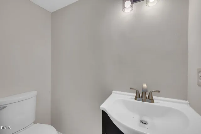 a bathroom with a sink mirror and toilet