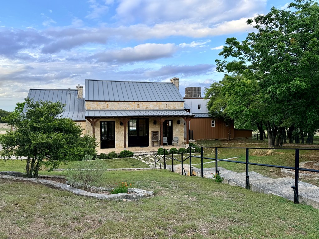 768 North Walnut Springs Road, Unit 26 Johnson City, TX 78636 - Photo 15 of 23 a view of a house with a yard and sitting area