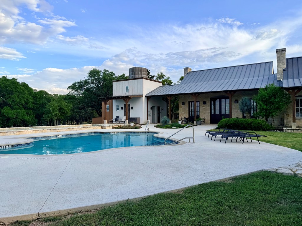768 North Walnut Springs Road, Unit 26 Johnson City, TX 78636 - Photo 16 of 23 a view of a house with sitting area and a yard