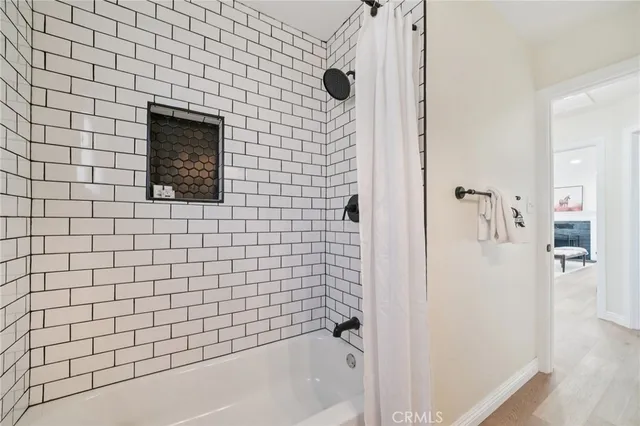 a bedroom with a bed and a ceiling fan