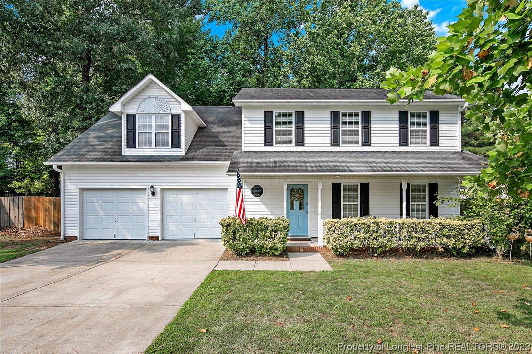 82 Hillandale Road Spring Lake, NC 28390 - Photo 1 of 50 a front view of a house with a yard and garage