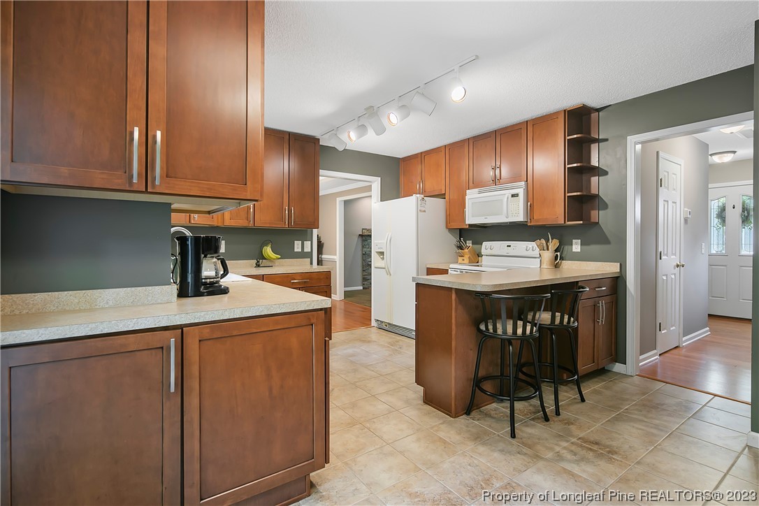 82 Hillandale Road Spring Lake, NC 28390 - Photo 15 of 50 a kitchen with a sink a refrigerator and cabinets