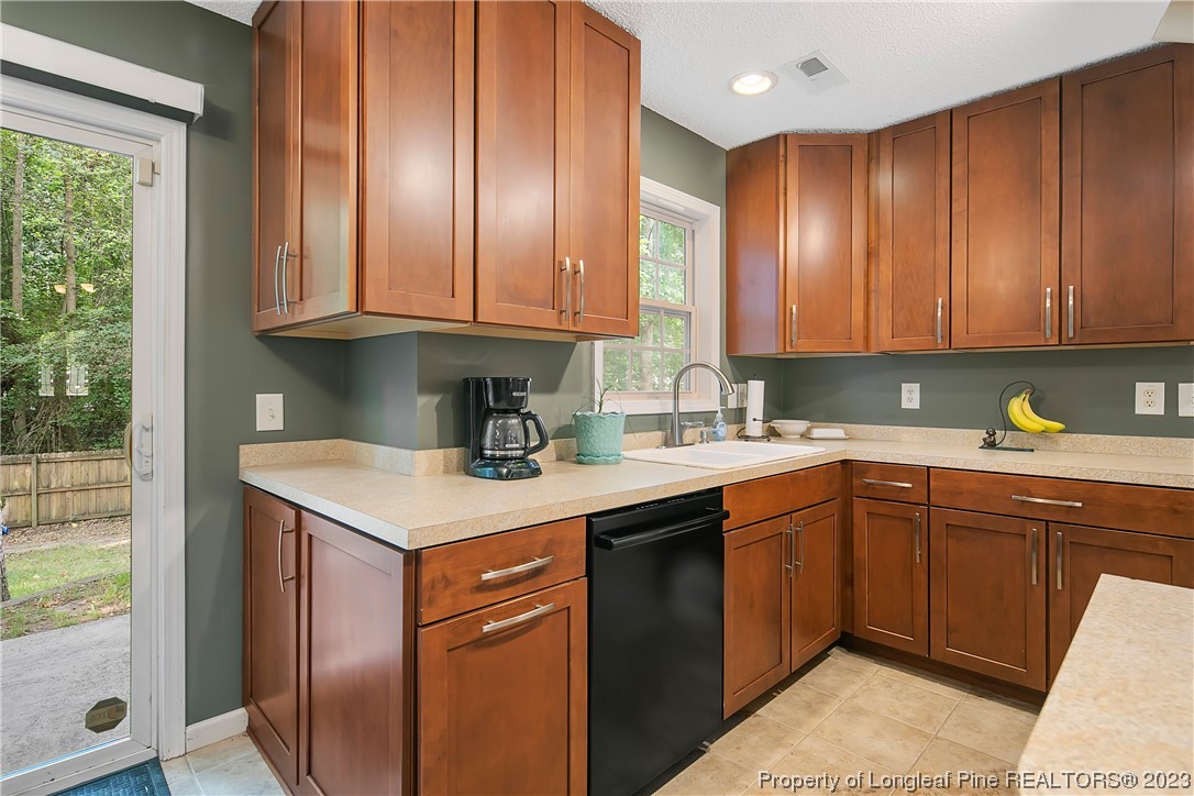 82 Hillandale Road Spring Lake, NC 28390 - Photo 18 of 50 a kitchen with stainless steel appliances granite countertop a sink stove and cabinets