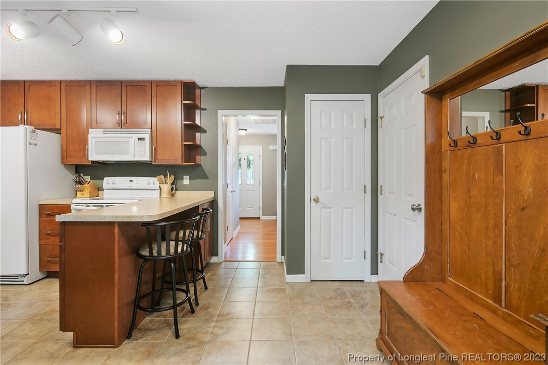 82 Hillandale Road Spring Lake, NC 28390 - Photo 19 of 50 a kitchen with stainless steel appliances kitchen island granite countertop furniture a refrigerator and a sink