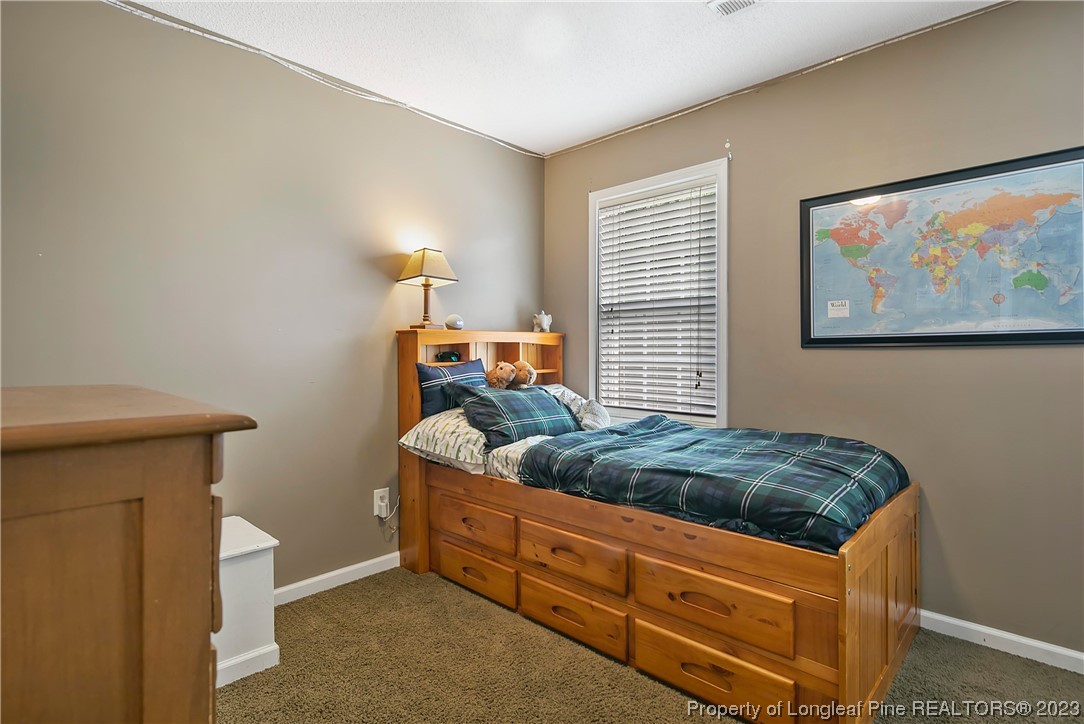 82 Hillandale Road Spring Lake, NC 28390 - Photo 36 of 50 a bedroom with a bed and a painting on the wall