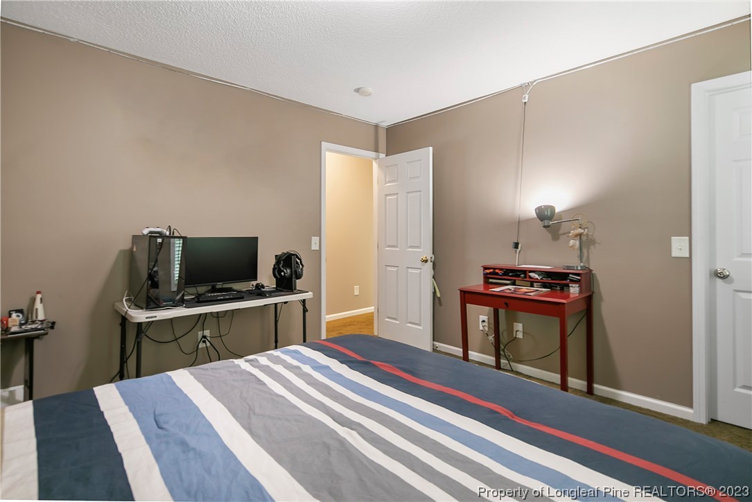 82 Hillandale Road Spring Lake, NC 28390 - Photo 39 of 50 a bedroom with a bed and a flat screen tv