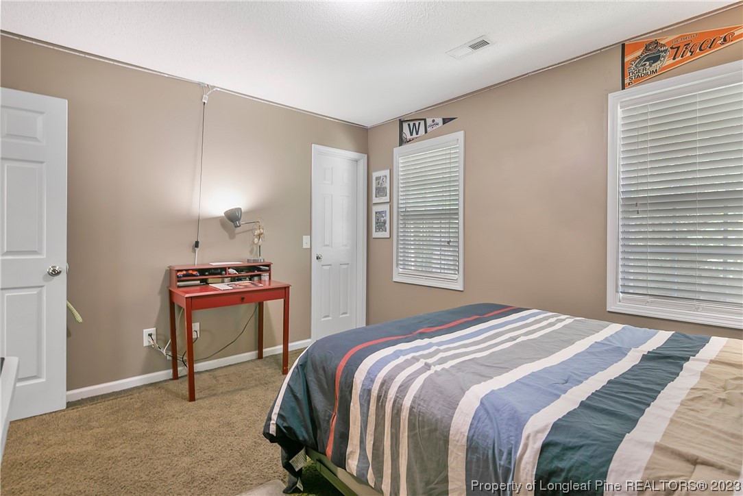 82 Hillandale Road Spring Lake, NC 28390 - Photo 41 of 50 a bedroom with a bed and a desk