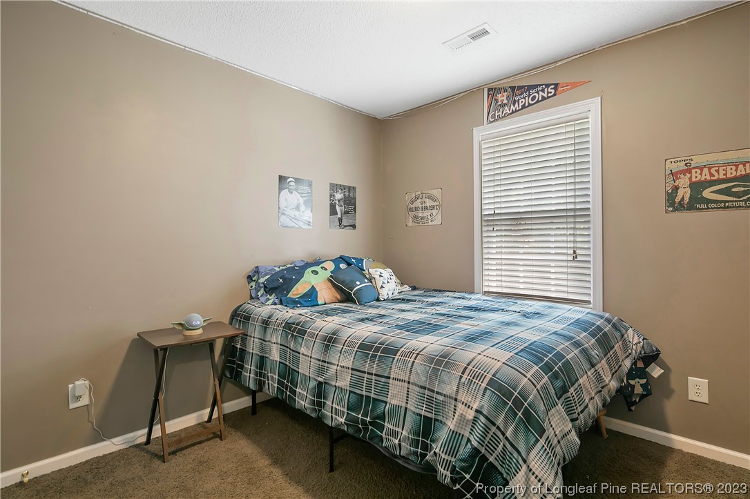 82 Hillandale Road Spring Lake, NC 28390 - Photo 45 of 50 a bedroom with a bed and a window