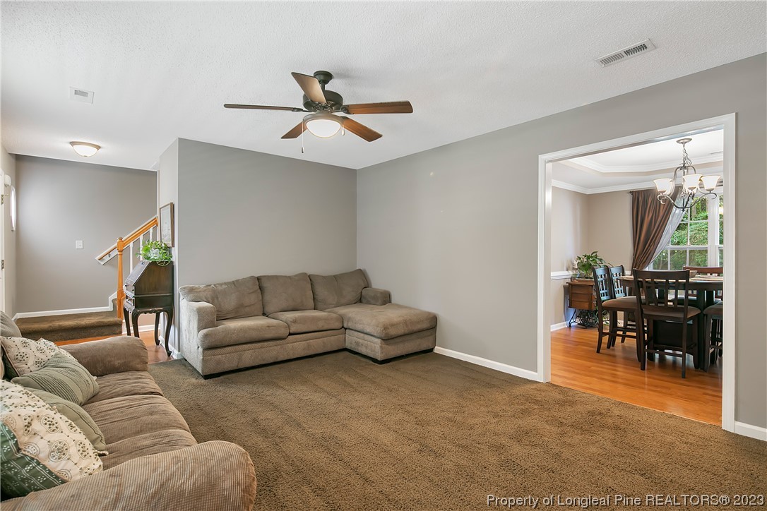 82 Hillandale Road Spring Lake, NC 28390 - Photo 10 of 50 a living room with furniture and a dining table with a potted plant